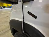 a close up of a white truck with a sticker on it ' s side