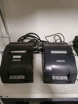 two receipt machines sitting on a shelf next to each other