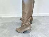 a close up of a woman ' s legs wearing knee high boots