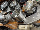 many pots and pans that are on a table
