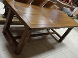 a wooden table that is sitting on a tile floor