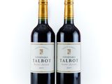 two bottles of red wine sitting next to each other on a white surface