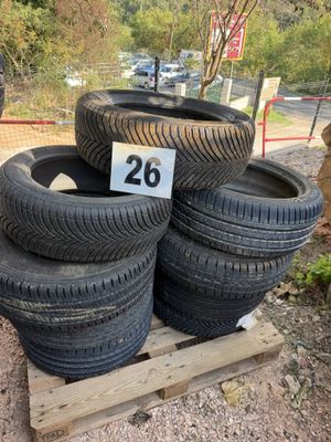 several tires are stacked on a pallet with a number 28 on them