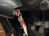 a car dashboard with a key hanging from it ' s handle