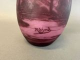 a purple vase with a black and white design on it