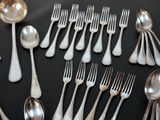 a lot of silver spoons and spoons on a table
