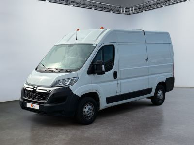 the white van is parked in a large room with white walls
