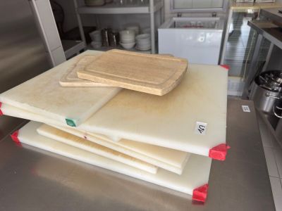 a stack of cutting boards sitting on top of a kitchen counter