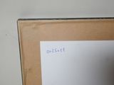 someone is writing on a piece of paper in front of a whiteboard
