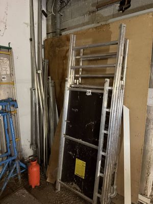 a room with a ladder, a chair, and a fire hydrant