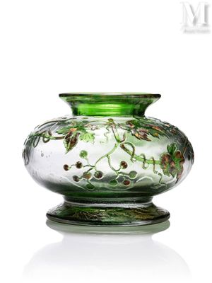 un vase en verre vert orné d'un motif floral