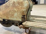 a rusted scooter that is sitting on the ground