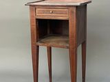 a small wooden table with a shelf on it