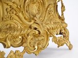 a gold clock that is sitting on a table