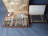 a wooden case with silverware in it on a table