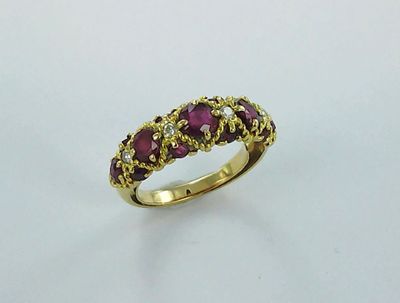 a close up of a gold ring with purple stones on it