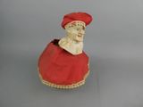 a figurine of a woman wearing a red dress and a red hat