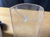 a clear plastic box with a hole in it sitting on a table