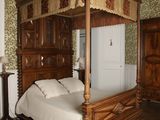 a bed with a canopy in the middle of a room