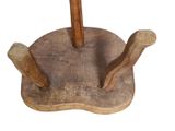 a wooden umbrella stand with a wooden handle on it