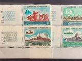 four stamps with a ship on them on a black surface