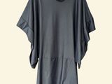 a gray shirt hanging on a hanger on a white wall