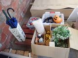 a cardboard box filled with assorted items sitting on a pallet