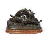 a bronze sculpture of a group of animals on a wooden base