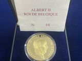 a close up of a gold coin in a box on a table