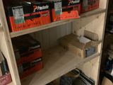 many boxes of tools on the shelves in the garage
