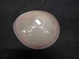 a white object on a black surface with a tag on it