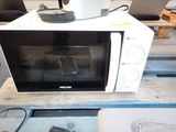 a microwave sitting on top of a wooden table