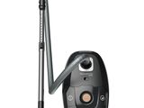 the black and silver vacuum is next to the black and silver vacuum