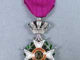 a close up of a medal with a purple ribbon on it