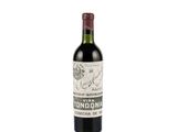 the bottle of wine is sitting on a white surface