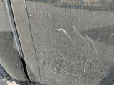 a close up of a car ' s door handle on the side of the road