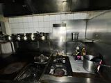 a kitchen with a stove and pots and pans