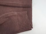 a close up of a brown sweater on a white table