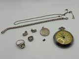 an assortment of jewelry including a pocket watch, a chain, a ring, a necklace, and a ring