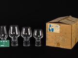 four wine glasses and a box on a black background