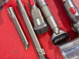 many different types of vacuum cleaners on a red surface