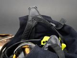 a black bag with a pair of shoes and a pair of headphones in it