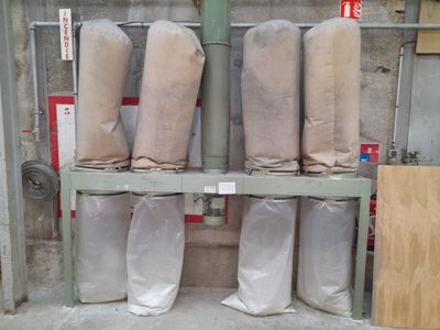 many rolls of fabric sitting on a shelf in a warehouse