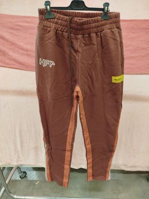 a pair of brown pants hanging on a clothes rack