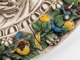 a close up of a decorative plate with a bird on it