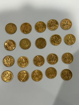 a lot of gold coins on a white surface