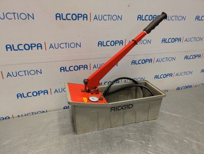 a bucket with a red handle sitting on top of a metal table
