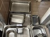 many trays and pans that are sitting on the floor