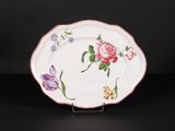 an image of a plate with flowers painted on it on a black surface