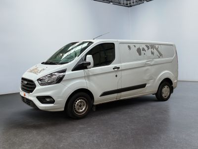 the white van is parked in a large room with a black floor